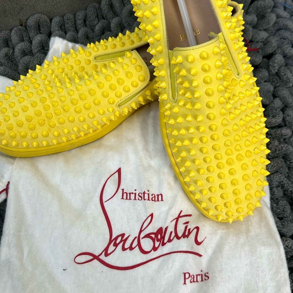 Men’s yellow spiked loafer made my Christian Louboutin.